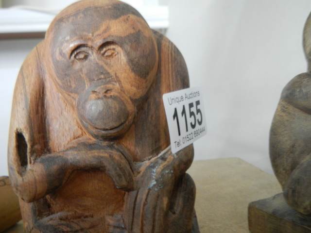 A carved wood figure of an orangutan and another carved ape figure. - Image 3 of 3