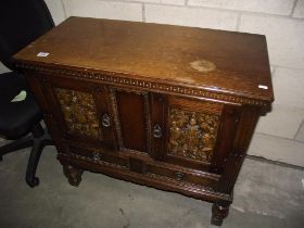 A crested carved side cabinet