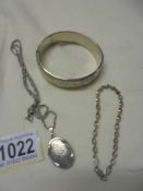 A silver locket, a silver bracelet and a silver bangle (bangle has dint). 36 grams (1.3 ozs).