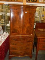 A Two door mahogany cocktail cabinet with four drawer base. COLLECT ONLY.