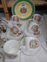 Six commemorative cups and saucers and a commemorative plate.