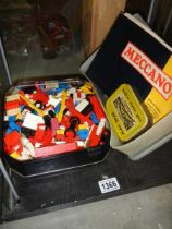 A tin of vintage Lego and a tin of vintage Meccano.
