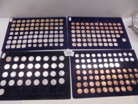 Four trays of decimal and pre-decimal coins.