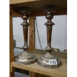 A pair of late Victorian silver plate candlesticks.