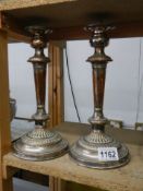 A pair of late Victorian silver plate candlesticks.