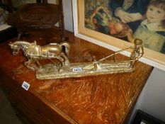 A 1960's solid brass horse with farmer pulling a plough.