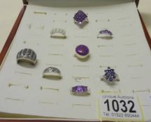A good quality ring case with eight assorted silver rings.