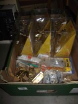 A quantity of new door handles etc in packaging