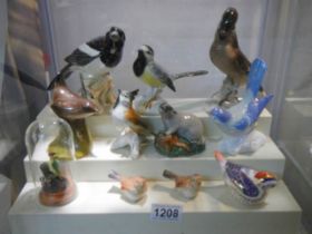 Ten various bird figures and a badger.