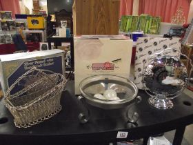 A silverplate wire bottle basket, candle set and vintage foldable cake stand with original box