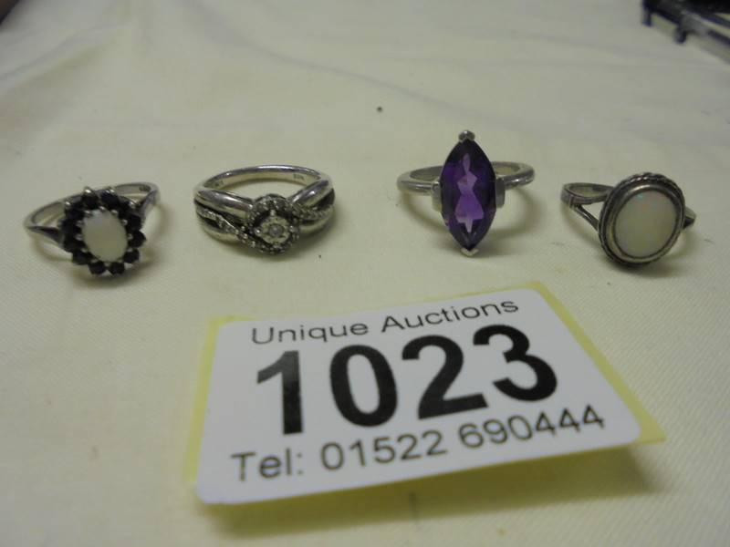 Four assorted silver rings.