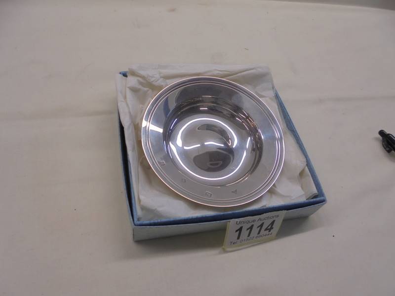 A hall marked silver wine tasting dish.