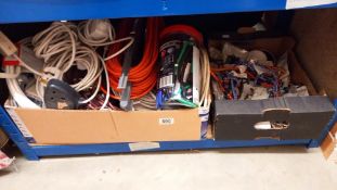 A quantity of extension leads, adapters, box of bungee cords etc