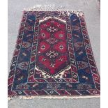 A blue/red patterned rug, 76" x 50" COLLECT ONLY