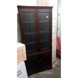 A dark oak corner cupboard with leaded glass doors COLLECT ONLY