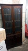 A dark oak corner cupboard with leaded glass doors COLLECT ONLY
