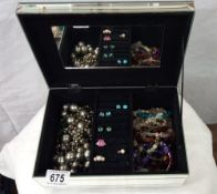 A glass jewellery box and contents