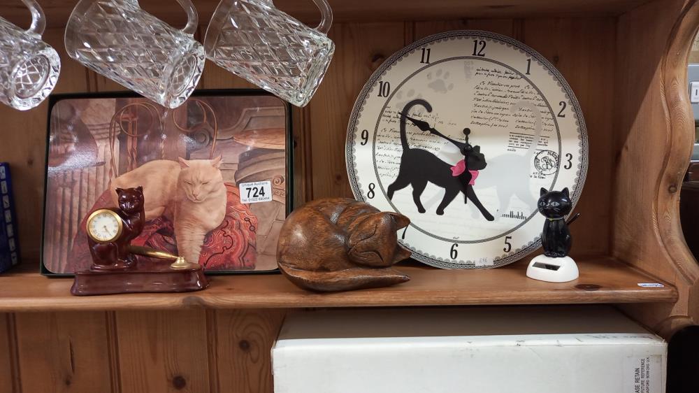 A cat clock, wooden cat, and other cat related items
