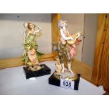 A pair of Italian figures on Carrera marble bases