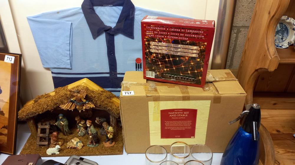 A boxed nativity set and box of Christmas lights (donkey in nativity is a/f)