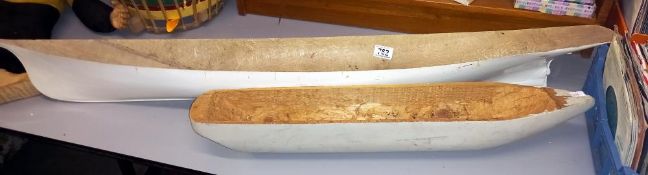A wooden model boat hull & a larger fibre glass boat hull COLLECT ONLY.