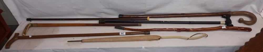A selection of walking sticks and a parasol