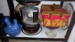 A shelf of kitchenalia including Pyrex, chicken egg dish, wicker basket etc