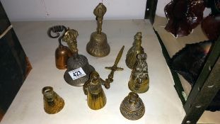 3 brass lady bells, 4 other bells and a letter opener