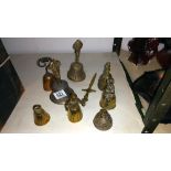 3 brass lady bells, 4 other bells and a letter opener