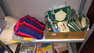 2 shelves of sewing/knitting/crocheting magazines, plus a knitted blanket, a crocheted blanket,