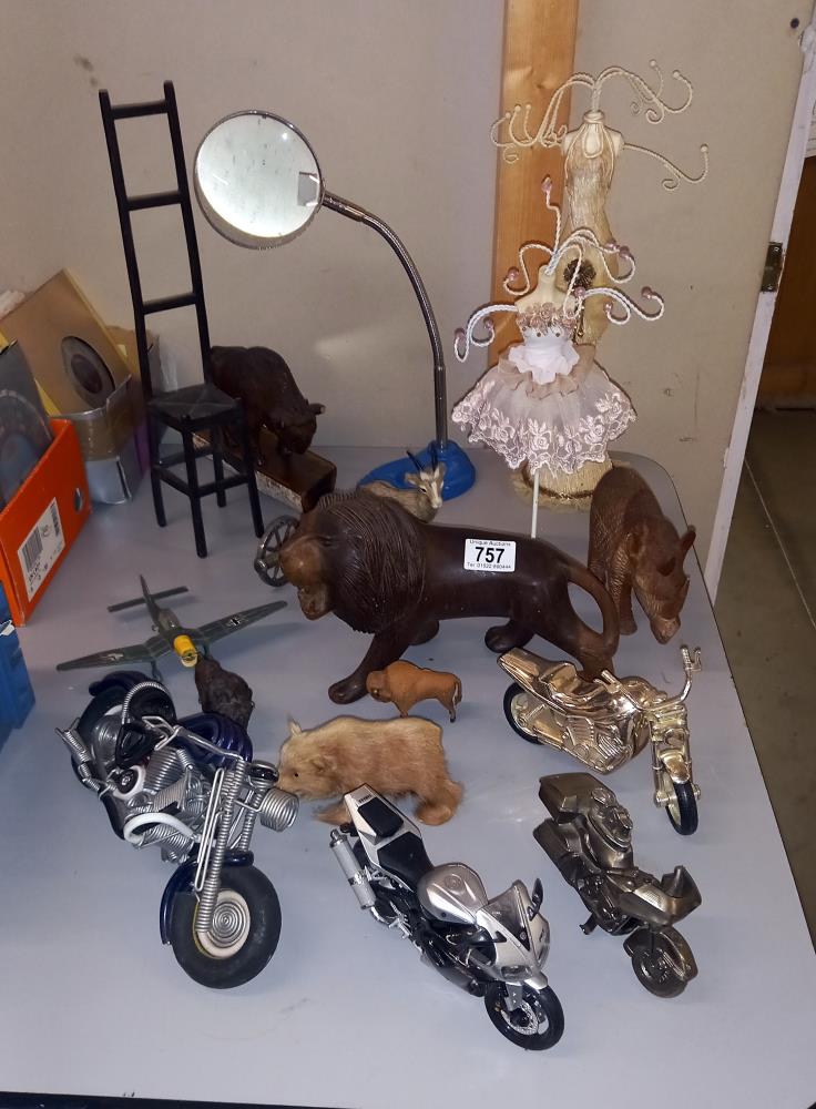 A mixed lot of figurines etc. including wooden animals, cannon, motorbikes & ladies ring holders
