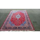 A red patterned rug, 128" x 83" approximately COLLECT ONLY