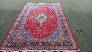 A red patterned rug, 128" x 83" approximately COLLECT ONLY