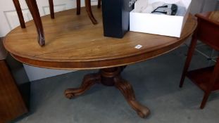 A Victorian mahogany oval table on carved tripod base COLLECT ONLY