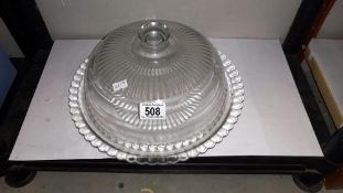 A glass domed lidded vintage cake display stand