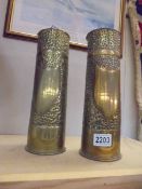 A pair of WW1 trench art decorated brass gun shells.