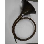 An unusual copper horn with multiple loops, approximate diameter 40cm, (missing mouthpiece).