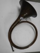 An unusual copper horn with multiple loops, approximate diameter 40cm, (missing mouthpiece).