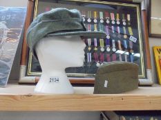 An East German Bomberger Mitzer hat size 56, a ski hat size 61 Stum Handels GNBH Rotterburg Deutch.