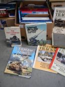 A box of books relating to tanks and aircraft.