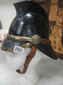 A Victorian fireman's helmet with coat of arms.