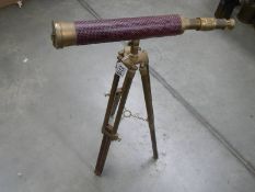 A reproduction brass telescope on tripod.