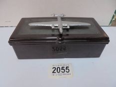 A vintage bakelite cigarette box with surmounted white metal aeroplane, 17 x 8.5 x 6 cm,