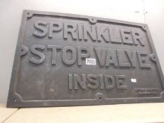 A large heavy cast iron sign, 'Sprinkler Stop Valve Inside', 58 x 27.5 cm.