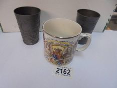 A Metal Edward VII coronation beaker, a metal German beaker and a 1935 silver jubilee mug.