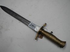 An early 29th century bayonet in scabbard with ribbed brass hilt, blade 30 cm.