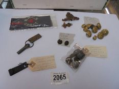 A collection of military items inc:- WW1 German uniform fittings, German C1918 steel chin strap