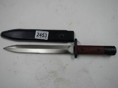 A bayonet in sheath with double edged blade, blade 21cm.