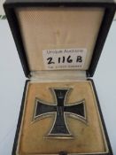 An Iron cross badge dated 1914.
