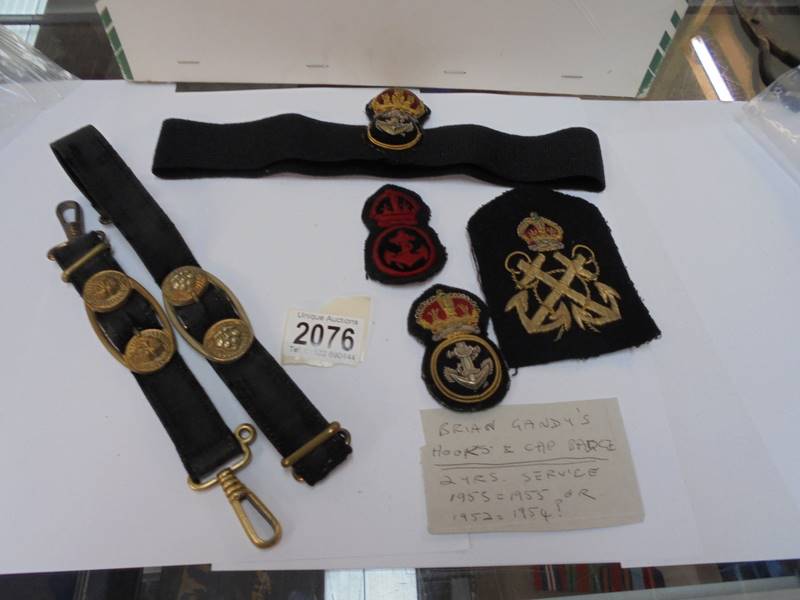 Hooks and cap badges supposedly belonging to Brian Gandy, 2 years service, 1952-1954 or 1953-1955.
